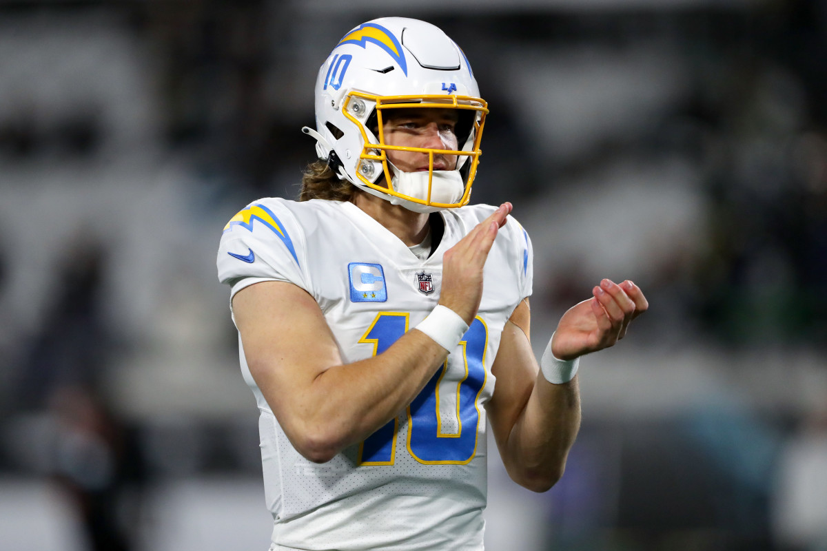 JACKSONVILLE, FLORIDA - JANUARY 14: Justin Herbert #10 of the Los Angeles Chargers warms up prior to a game against the Jacksonville Jaguars in the AFC Wild Card playoff game at TIAA Bank Field on January 14, 2023 in Jacksonville, Florida. (Photo by Courtney Culbreath/Getty Images)