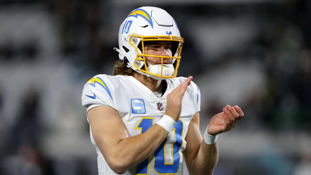 JACKSONVILLE, FLORIDA - JANUARY 14: Justin Herbert #10 of the Los Angeles Chargers warms up prior to a game against the Jacksonville Jaguars in the AFC Wild Card playoff game at TIAA Bank Field on January 14, 2023 in Jacksonville, Florida. (Photo by Courtney Culbreath/Getty Images)