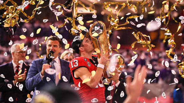INGLEWOOD, CA - JANUARY 09: Georgia Bulldogs quarterback Stetson Bennett (13) kisses the championship trophy after the Georgia Bulldogs defeated the TCU Horned Frogs in the College Football Playoff National Championship game on January 9, 2023, at SoFi Stadium in Inglewood, CA. (Photo by Brian Rothmuller/Icon Sportswire via Getty Images)
