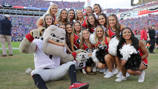 Uga X posing with the Georgia Bulldogs cheerleading squad.