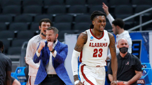John Petty Jr. #23 of the Alabama Crimson Tide reacts as head coach Nate Oats looks on in the second half against the Maryland Terrapins in the second round game of the 2021 NCAA Men's Basketball Tournament