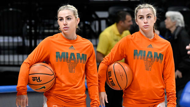 PITTSBURGH, PENNSYLVANIA - JANUARY 01: Haley Cavinder #14 (L) and Hanna Cavinder #15 (R) of the Miami Hurricanes warm up before the game against the Pittsburgh Panthers at Petersen Events Center on January 01, 2023 in Pittsburgh, Pennsylvania. (Photo by G Fiume/Getty Images)