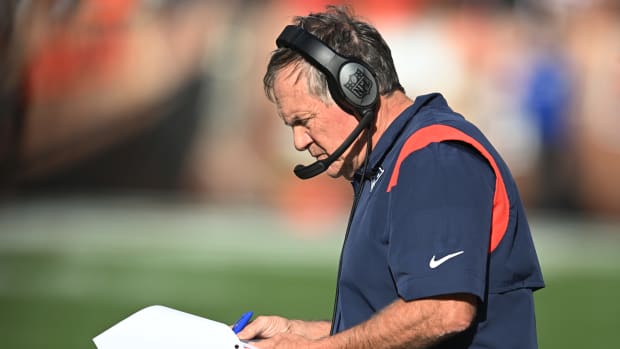 Bill Belichick looks at his playsheet during a game.