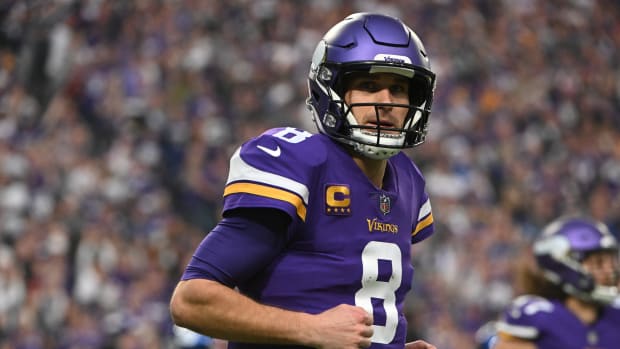 Kirk Cousins of the Vikings plays on the field.